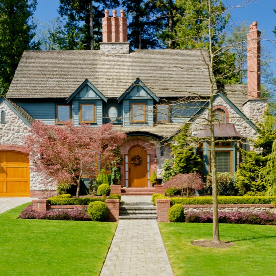Single family blue home with wood doors